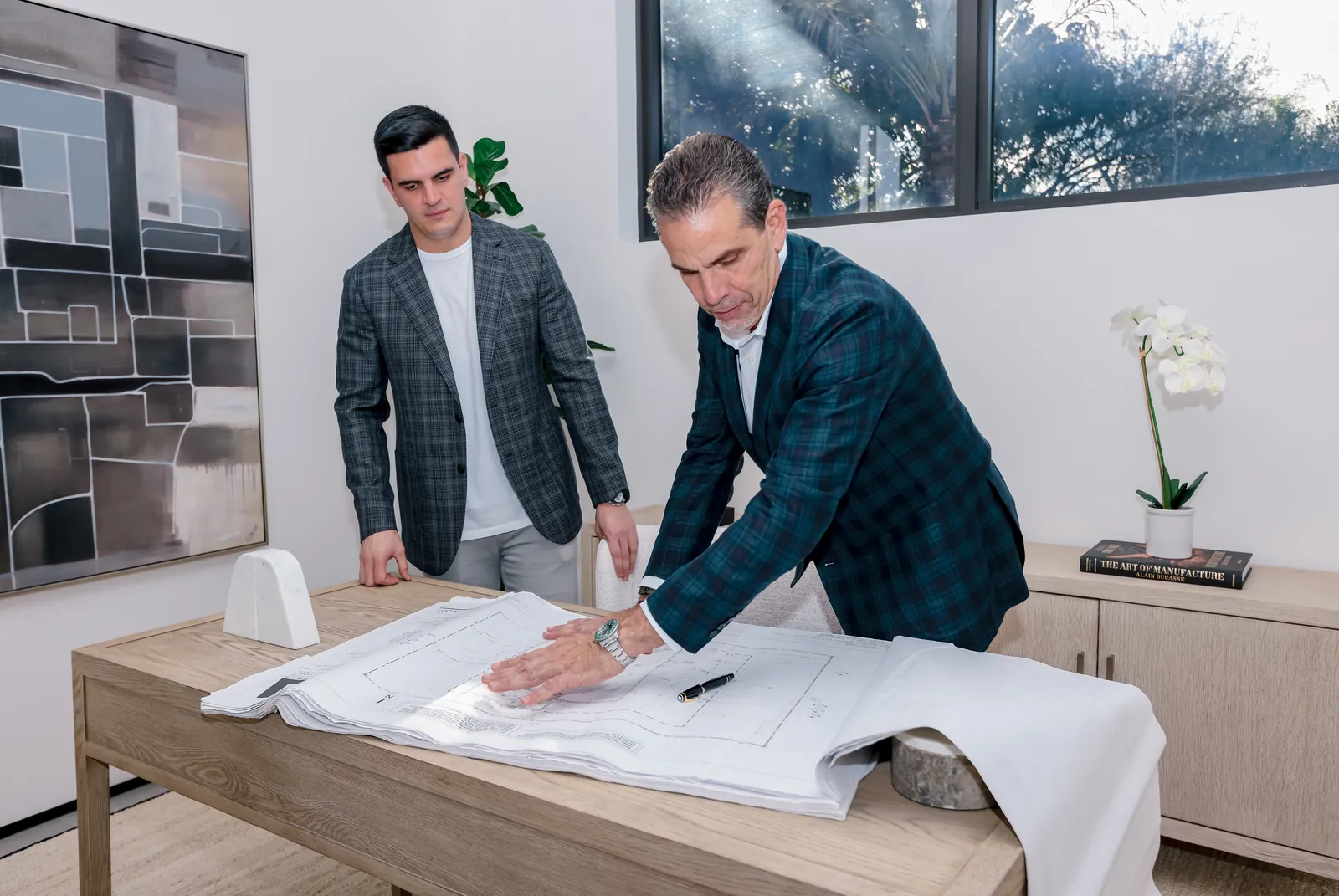 Luis Rodriguez Sr. and Luis Rodriguez Jr. reviewing plans